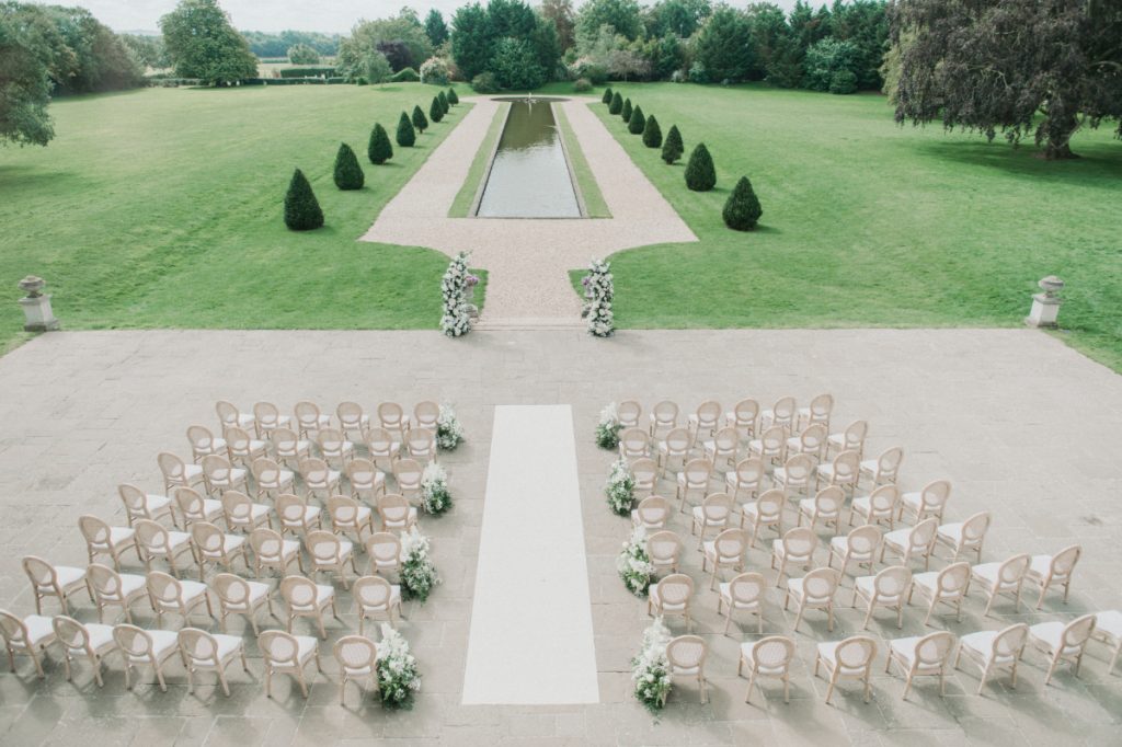 Chairs set out for a ceremony on the terrace, facing the formal garden