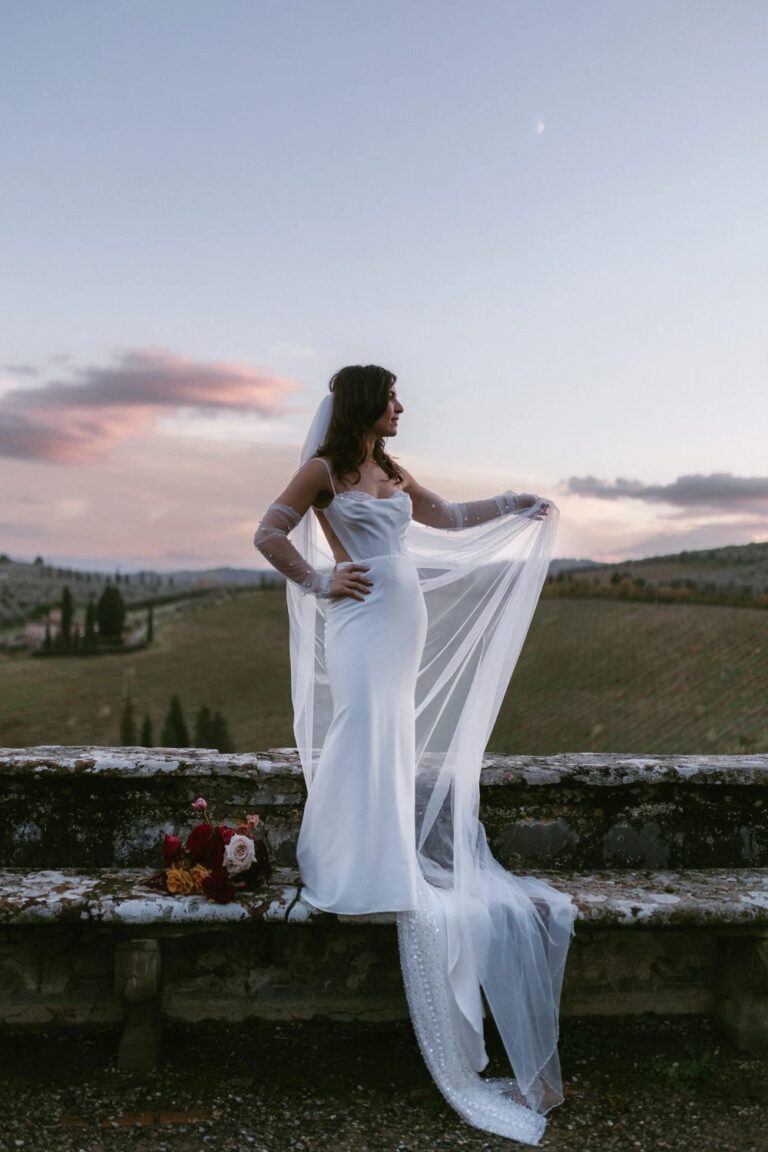 A bride on the stone balustrade at dusk, the Tuscan hills behind, Villa Corsini a Mezzomonte, Studio Fotografico Bacci