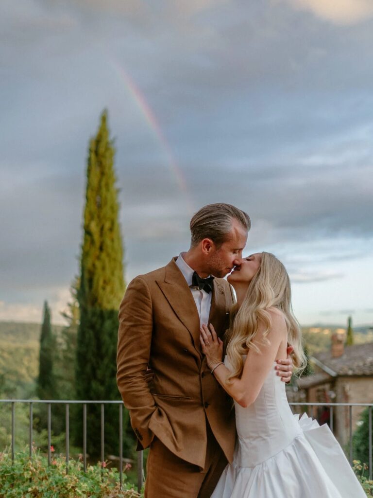 A kiss beside a cypress with a faint rainbow overhead, Borgo Casabianca, Tuscany, Studio Fotografico Bacci
