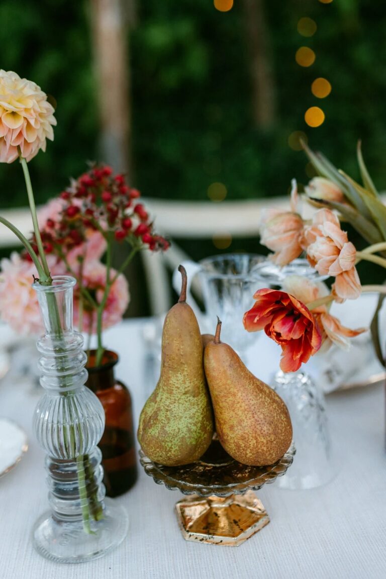 Pears, glass bud vases and garden flowers on a wedding table in Tuscany, Studio Fotografico Bacci