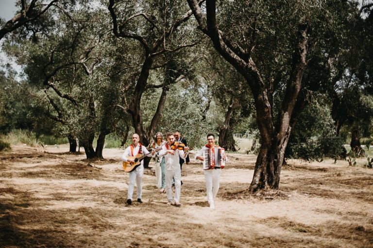 Musicians walking in through the olive grove, Studio27 by Andreas Politis Photography and Cinematography