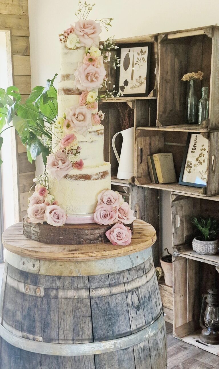 A tiered cake with pink sugar roses on a barrel, Sugar and Spiced Cakes