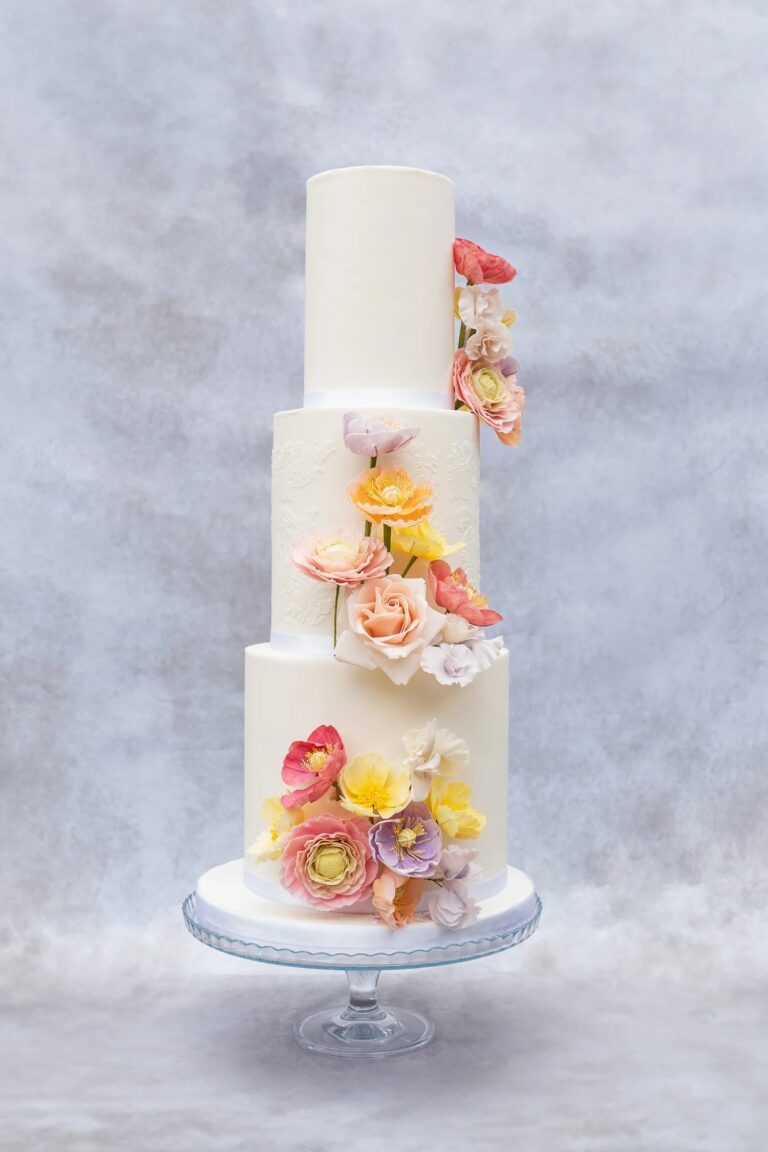 A three-tier white cake with bright hand-made sugar flowers, Sugar and Spiced Cakes