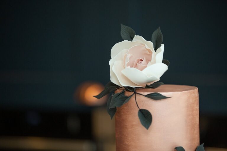 A copper-toned cake topped with a sugar rose, Sugar and Spiced Cakes