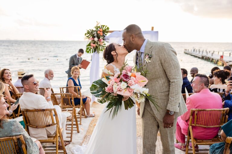 Couple's first kiss at a seaside ceremony, SunHorse Weddings