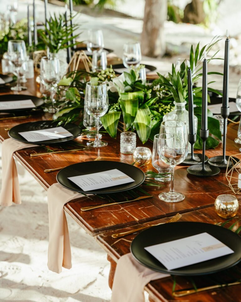 Wooden reception table with greenery and place settings, SunHorse Weddings