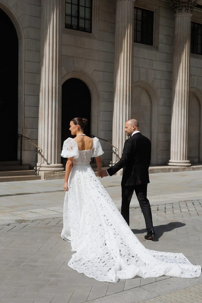 Emily and John, hand in hand beneath the colonnade, The Ned, Sweet Pea Floral Design