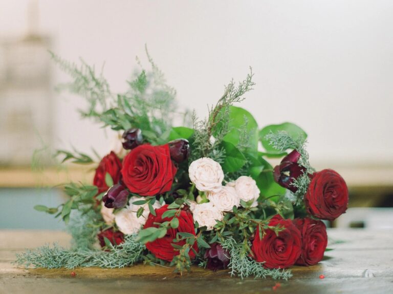 A seasonal arrangement of red and white roses, Sweet Pea Floral Design