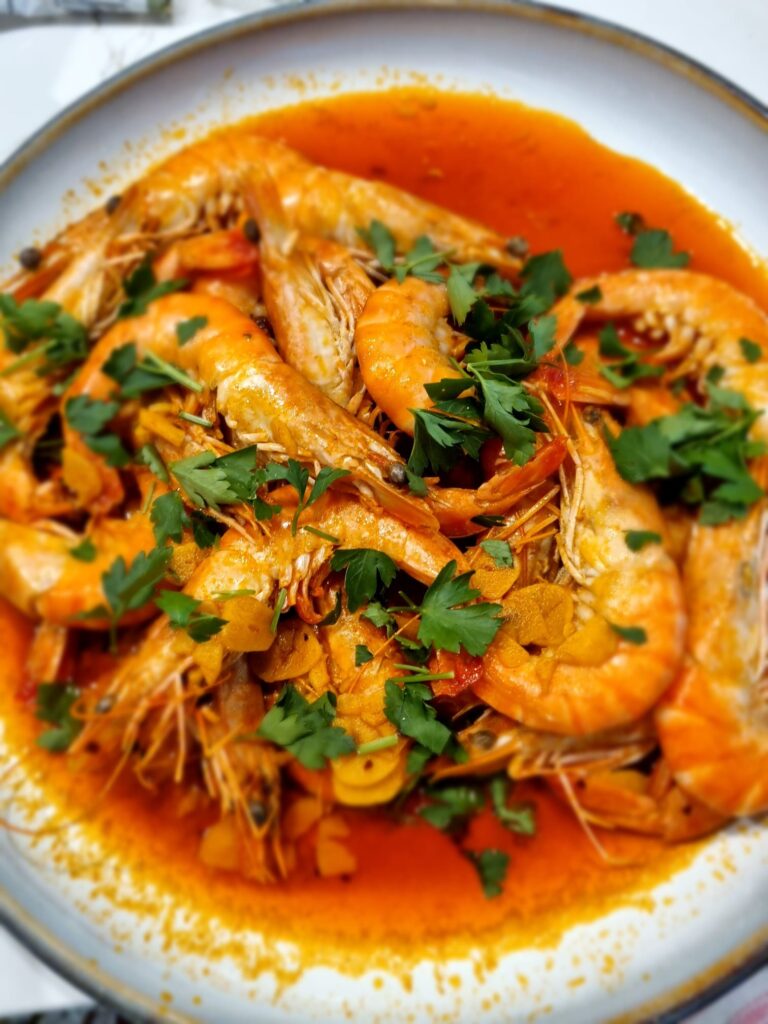 A bowl of prawns in a spiced tomato sauce with parsley, Tan House Newland