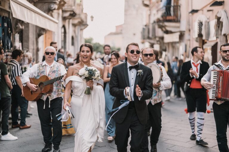 The couple walking the main street behind a Sicilian folk band, Taormina Weddings