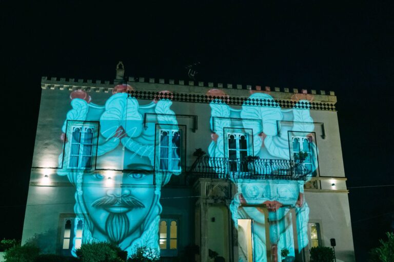 A Sicilian Moor's head (testa di moro) projected onto a villa facade at night, Taormina Weddings