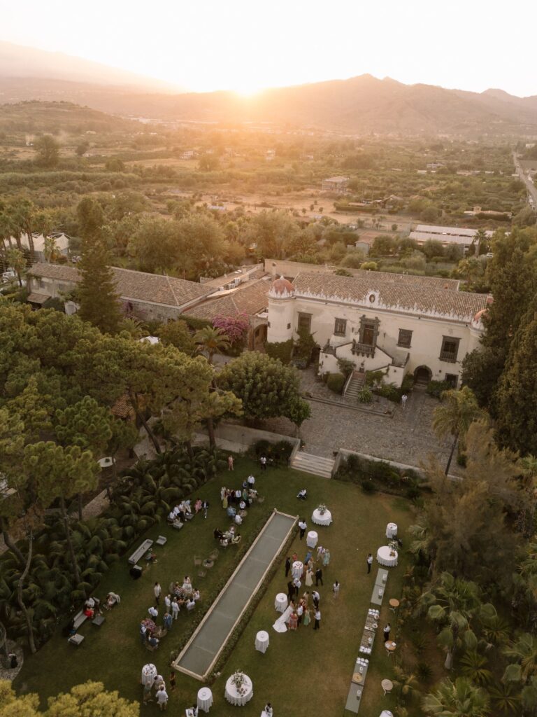 A villa and its reflecting pool from the air at sunset, the hills and Etna beyond, Taormina Weddings