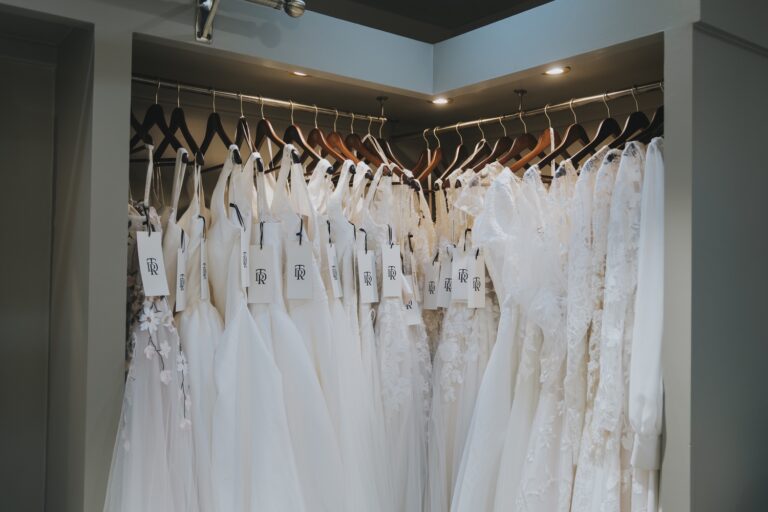 A corner rail filled with tulle and lace wedding dresses, TDR Bridal