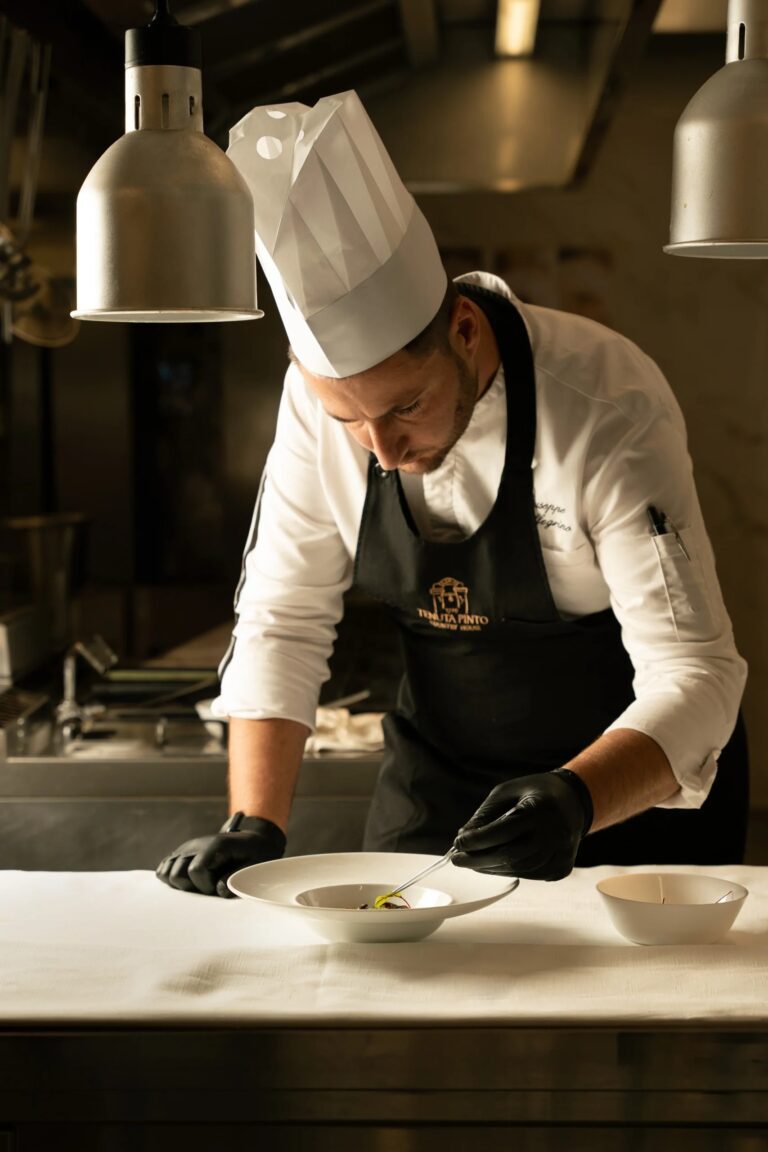A chef plates a dish in the Tenuta Pinto kitchen, Tenuta Pinto