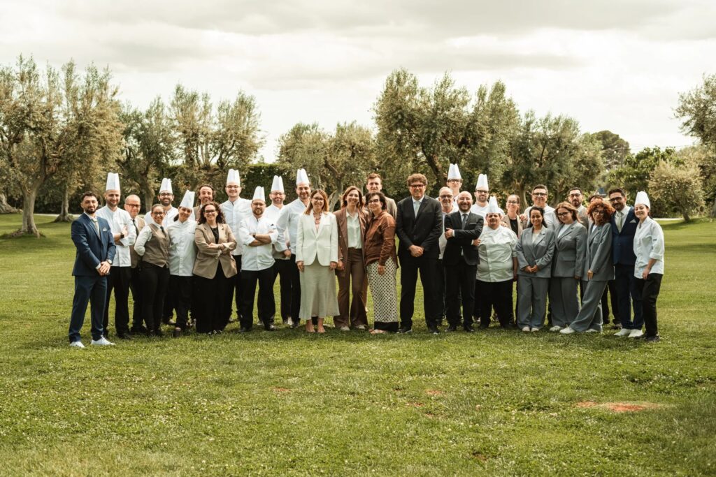 The Pinto family and the Tenuta Pinto team on the lawn among the olive trees, Tenuta Pinto
