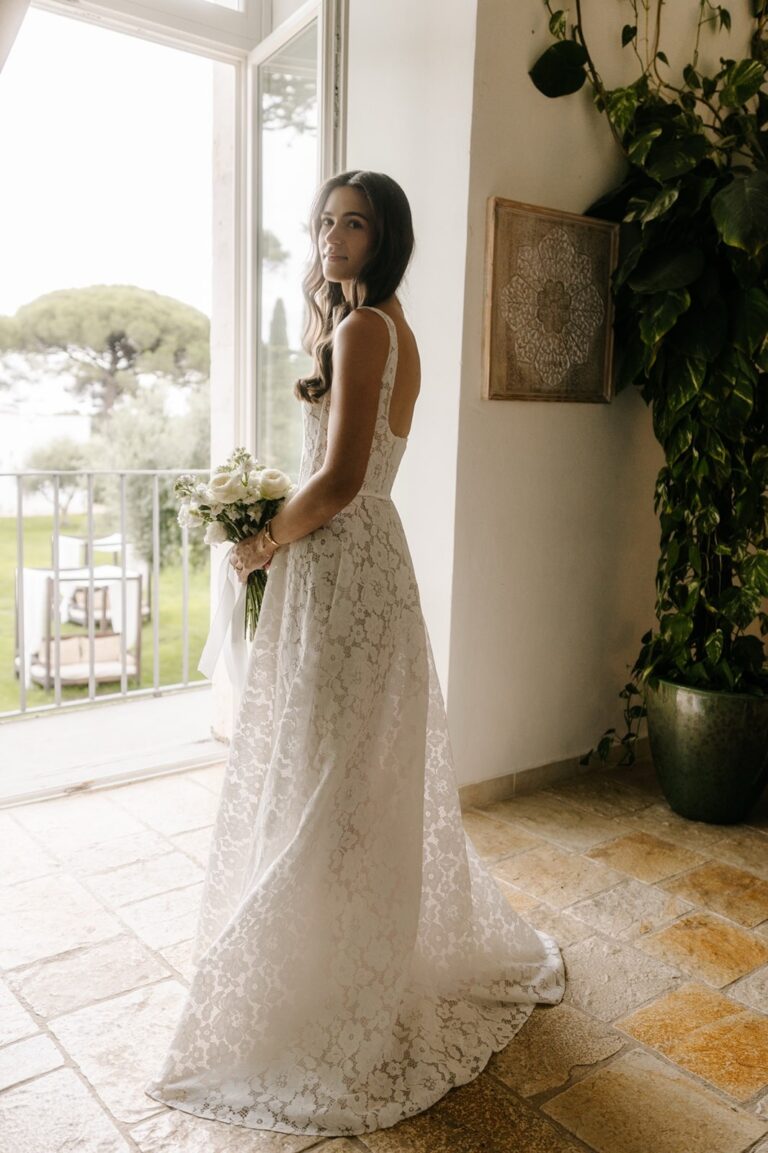 The bride beside a tall window in the masseria, Tenuta Pinto