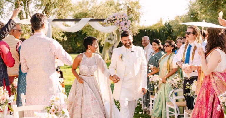 Suresh and Madhu walk back along the aisle as guests look on, Tenuta Pinto