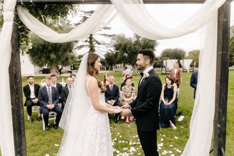 Thomas and Claudia exchange vows under a draped arch in the garden, 1 October 2025, Tenuta Pinto