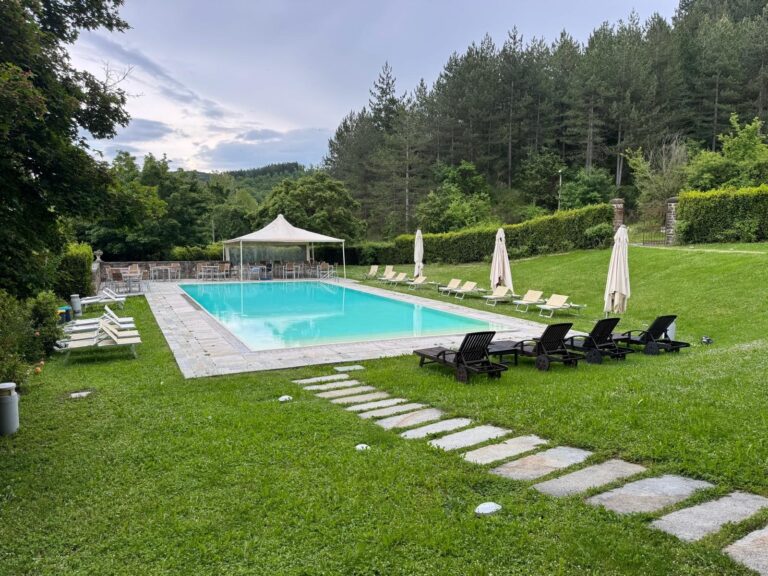 The pool, sun-loungers and stone paths in the park above the valley, The Abbazia San Faustino