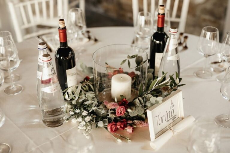 A wedding table dressed with candles, an olive wreath and Umbrian wine, The Abbazia San Faustino