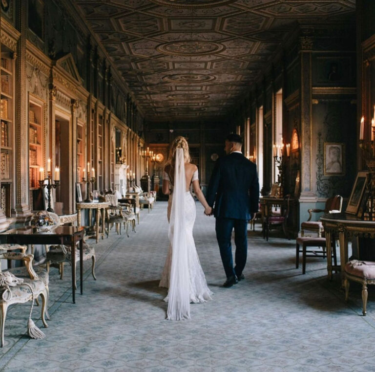 Bride and groom walking the length of a panelled long gallery, The Admirable Crichton