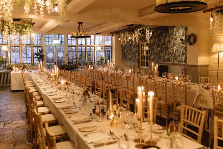 Long candlelit banqueting tables in the Conservatory, The Bay Tree Hotel