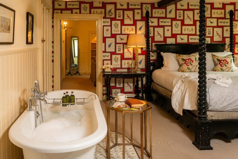The Oak Room suite, a carved four-poster and roll-top bath, The Bay Tree Hotel