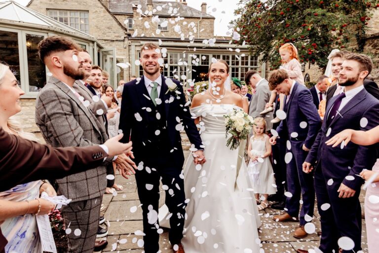 A confetti walk through guests in the courtyard, the conservatory behind, The Bay Tree Hotel
