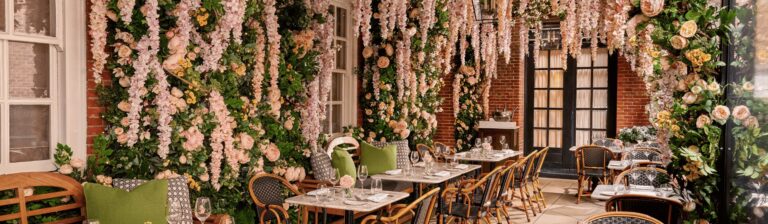 Dalloway Terrace in spring, with cascades of pink and white blossom over the tables, The Bloomsbury