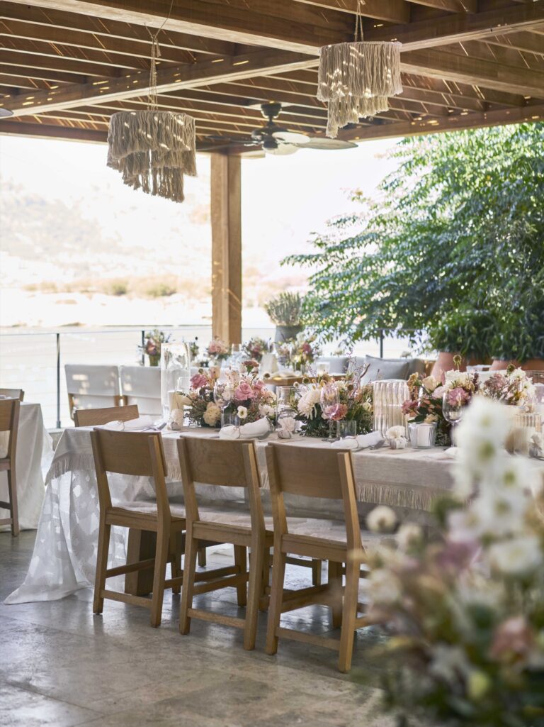 A wedding table set beneath a timber pergola, The Bodrum Edition