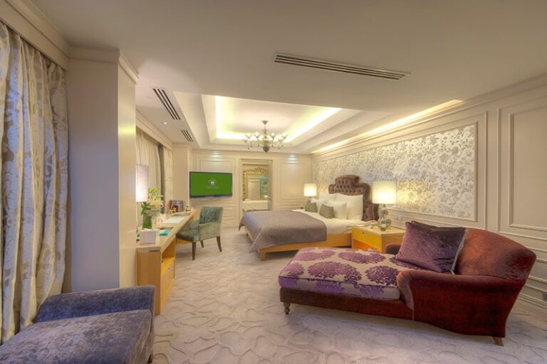 Suite bedroom with seating area, The Chateau Spa and Organic Wellness Resort