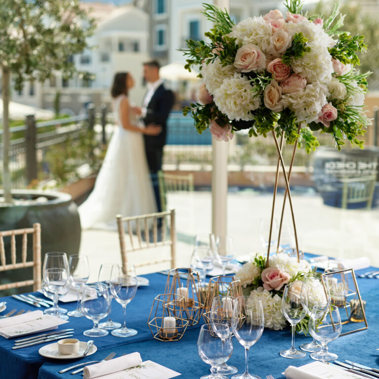 A long table with blue linen and floral centrepieces, The Chedi Luštica Bay