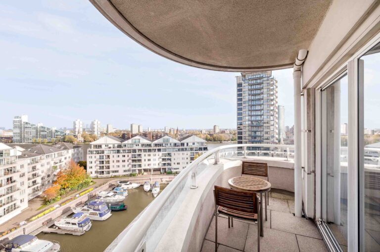 A Marina View Suite balcony with a table for two, looking over the harbour and the river, The Chelsea Harbour Hotel
