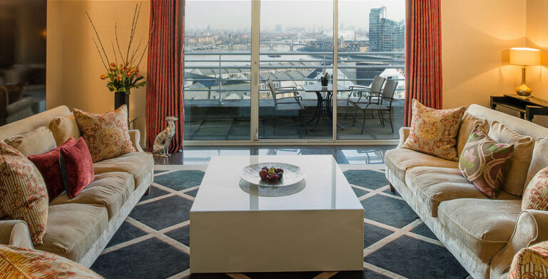 The Kings Penthouse Suite living room, sofas facing glass doors onto a terrace above the river, The Chelsea Harbour Hotel