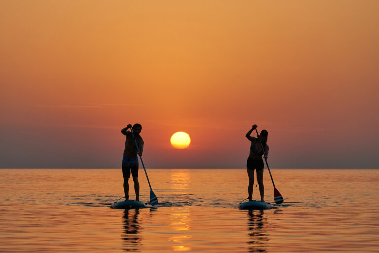 Paddleboarders at sunset, The Cotton House