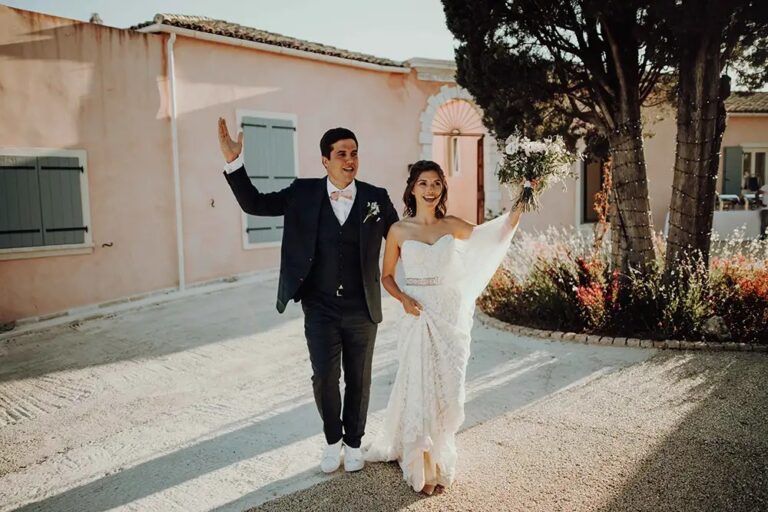 A couple walking out after the ceremony in the courtyard, The Courti Estate