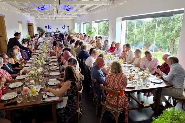 Guests at a long wedding breakfast table, The Courti Estate