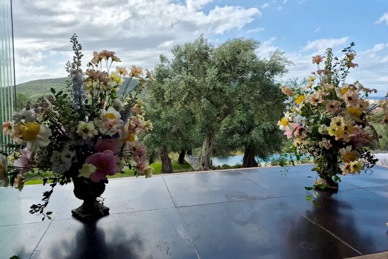 Flowers on the dining table with the olive groves behind, The Courti Estate