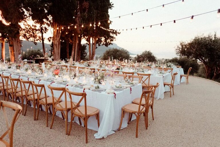 Long wedding tables at dusk in the grounds, The Courti Estate