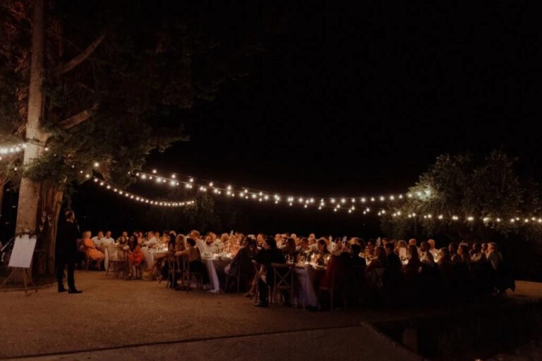 A wedding dinner under festoon lights, The Courti Estate