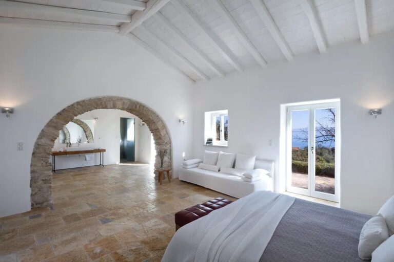A bedroom suite with a stone archway, The Courti Estate