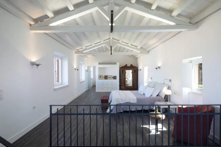 A first-floor bedroom under the beamed roof, The Courti Estate