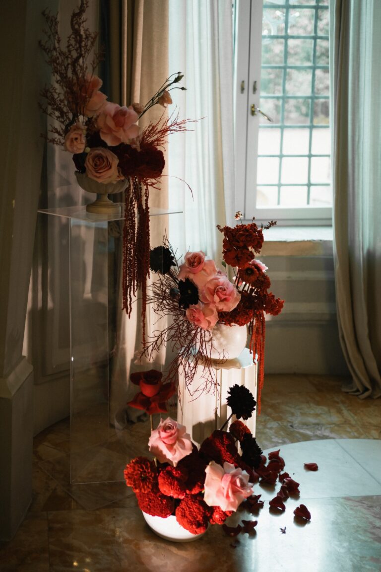 Red and pink flower installation indoors, villa in Rome, The Dream Wedding Lab