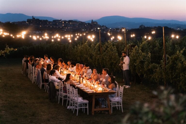 Candlelit dinner under string lights at dusk, Marche hills, The Dream Wedding Lab