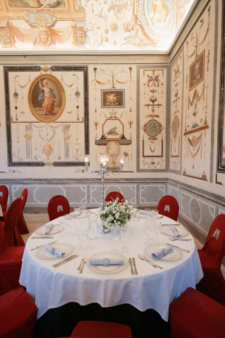 Round table in a frescoed dining room, castle wedding near Rome, The Dream Wedding Lab