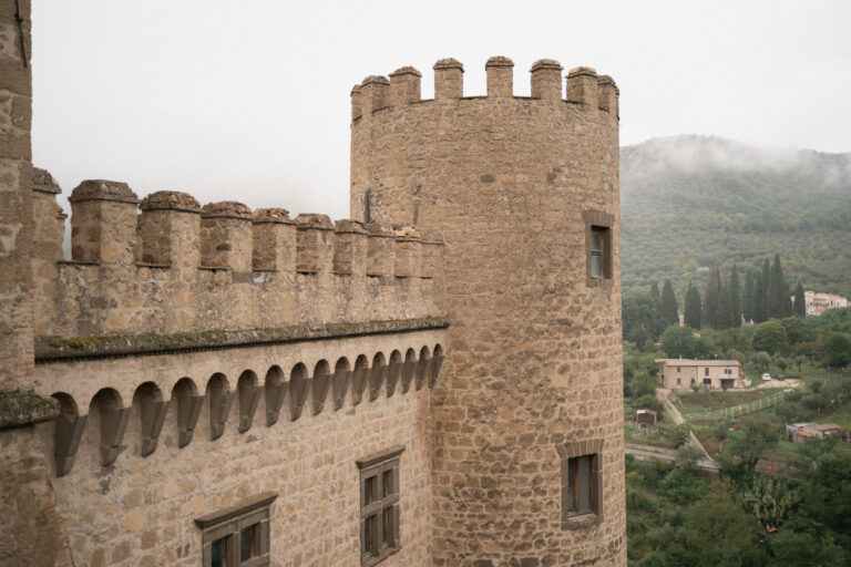 Castle walls and towers above wooded hills, castle wedding near Rome, The Dream Wedding Lab