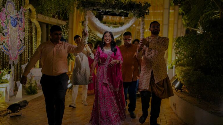 A wedding procession beneath lanterns and garden lights at an Indian celebration, The Event Studio