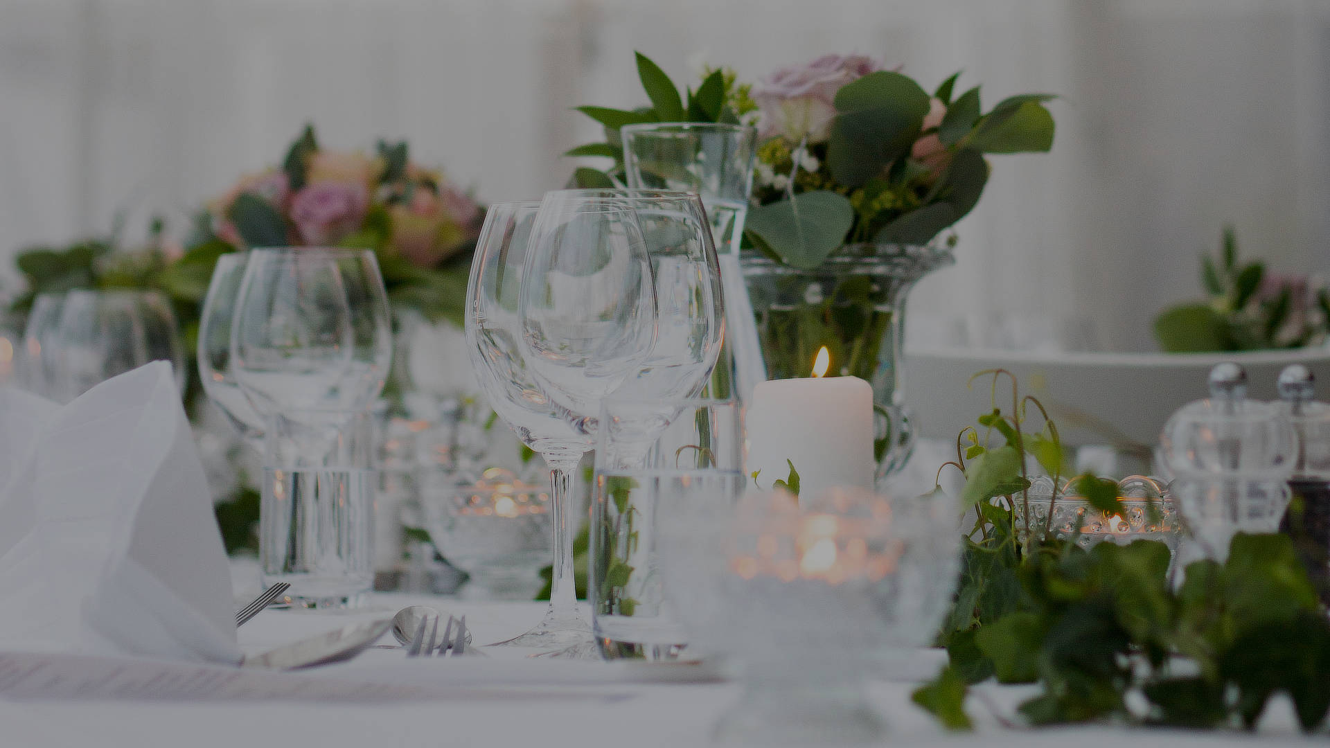 Glassware, candles and low florals on a laid table, The Event Studio