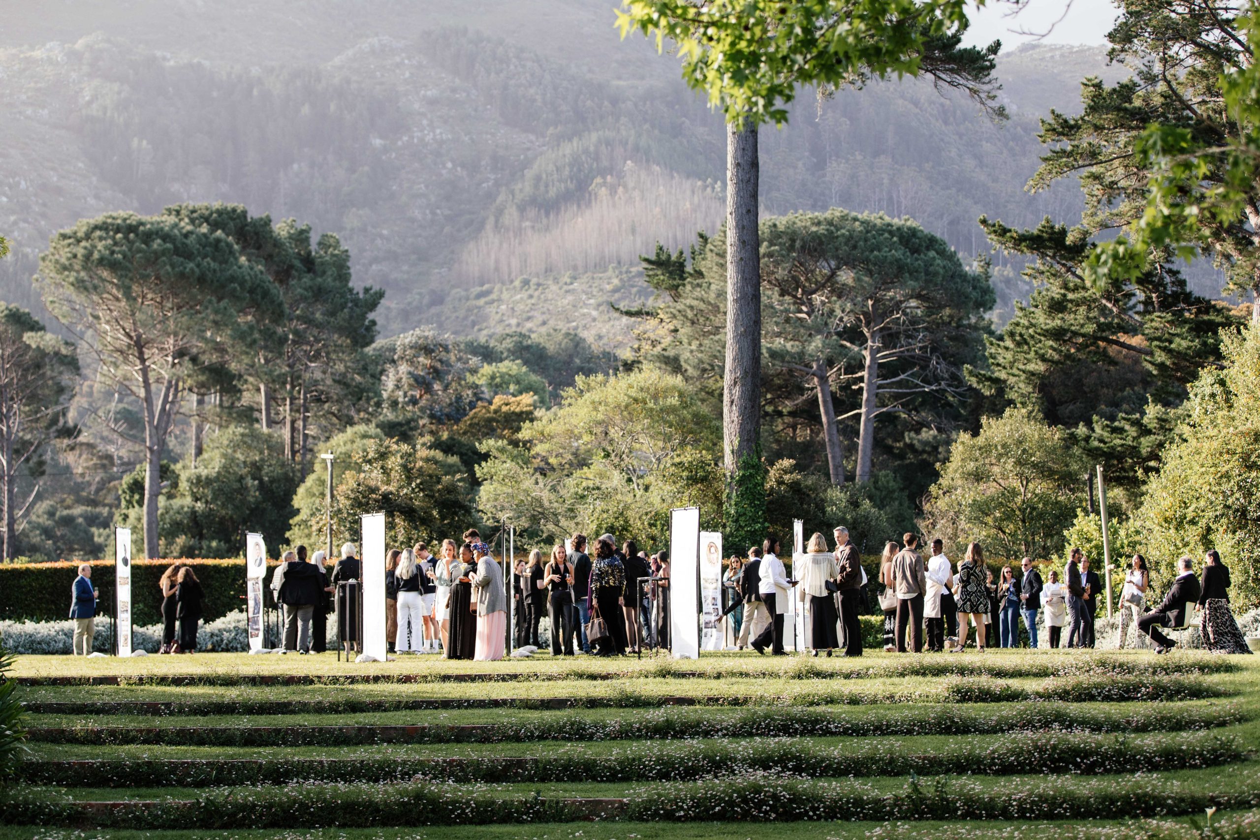 Guests gathered on the terraced lawn below the mountain slopes, The Forum Embassy Hill