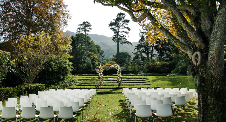 White chairs and a floral arch on the terraced lawn, The Forum Embassy Hill